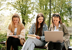 Students studying outdoors on laptop